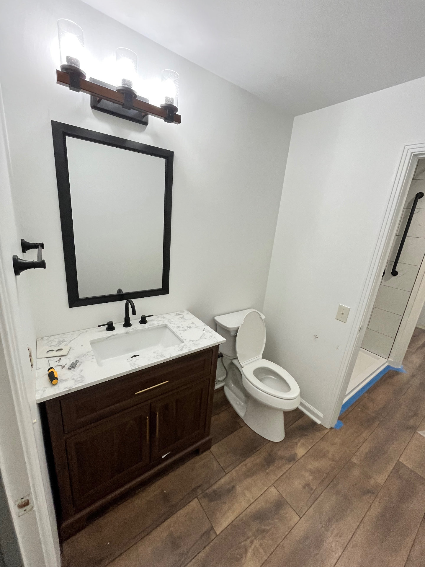 Finished vanity with quartz top & wood-look tile floor