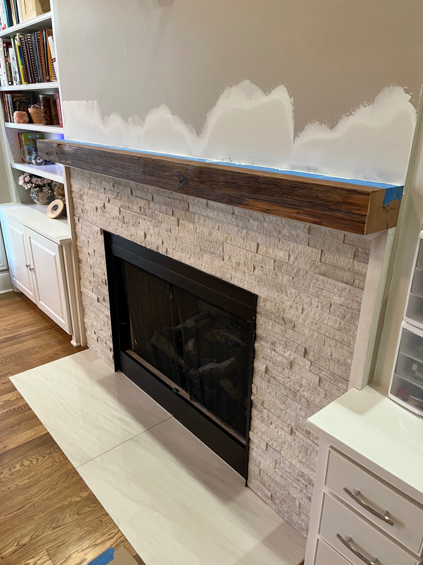 Stacked stone with reclaimed wood mantel
