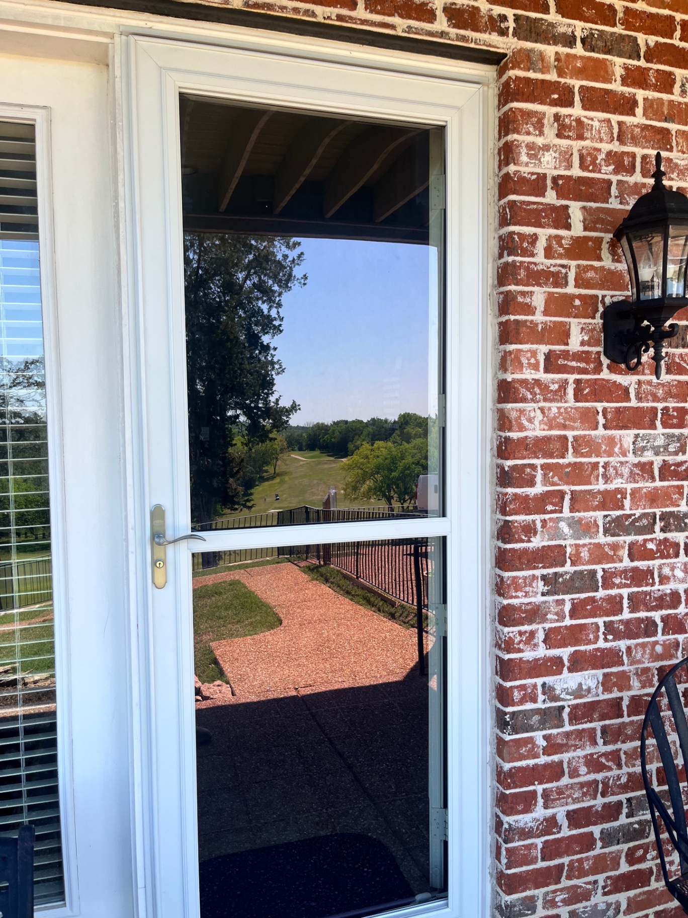 Full-view storm door on covered porch